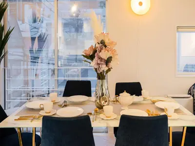 a dining room table with a vase of flowers at Meguro Sta 2 min , Shirokanedai Sta 2 min ,Family & Group Friendly,Switch,Wi-Fi in Tokyo
