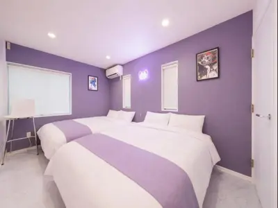 two beds in a bedroom with purple walls at Meguro Sta 2 min , Shirokanedai Sta 2 min ,Family & Group Friendly,Switch,Wi-Fi in Tokyo