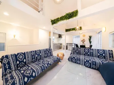 a living room with blue and white couches at Meguro Sta 2 min , Shirokanedai Sta 2 min ,Family & Group Friendly,Switch,Wi-Fi in Tokyo
