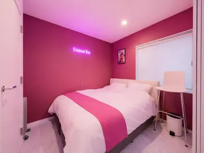 a purple bedroom with a bed and a sign that reads heartbeat at Meguro Sta 2 min , Shirokanedai Sta 2 min ,Family & Group Friendly,Switch,Wi-Fi in Tokyo