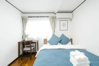 a bedroom with a blue bed and a desk at Magome tokyo stay in Tokyo