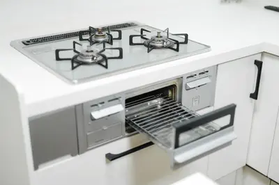 a stove top oven with two pots and pans on it at Magome tokyo stay in Tokyo