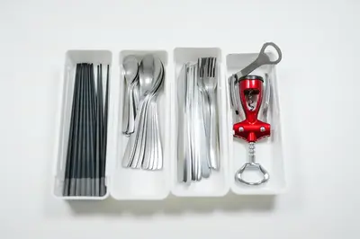 a drawer filled with silver utensils and a red spoon at Magome tokyo stay in Tokyo