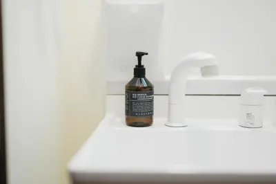 a bottle of soap sitting on a bathroom sink at Magome tokyo stay in Tokyo