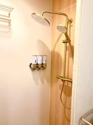 a bathroom with a shower with lights on the wall at Designers apartment Shibuya Shinjuku area in Tokyo