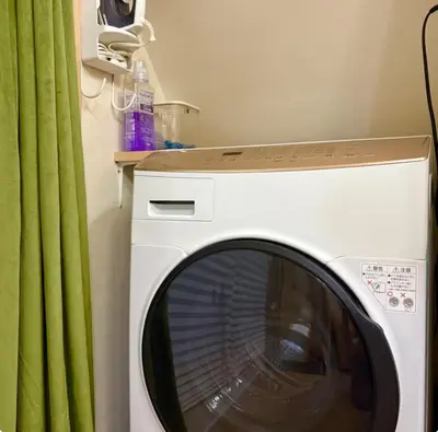 a white washing machine in a room with a green curtain at Designers apartment Shibuya Shinjuku area in Tokyo