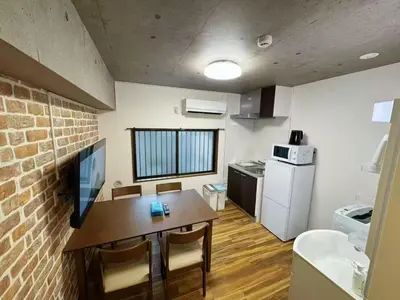 a kitchen with a table and a brick wall at NYCottageAnnex2\u5ba41\u30ea\u30d3\u30f3\u30b01\u30b7\u30e3\u30ef\u30fc1\u30c8\u30a4\u30ec in Tokyo