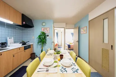 a kitchen with a dining table and yellow chairs at Shamrock Aoto 202 Cozy Tokyo Stay Near Station Airport Disney Access in Tokyo
