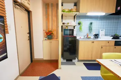 a small kitchen with a refrigerator and a sink at Shamrock Aoto 202 Cozy Tokyo Stay Near Station Airport Disney Access in Tokyo