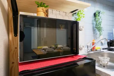a microwave sitting on top of a kitchen at Shamrock Aoto 202 Cozy Tokyo Stay Near Station Airport Disney Access in Tokyo