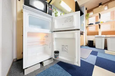 a refrigerator with its door open in a room at Shamrock Aoto 301 Cozy Tokyo Stay Near Station Airport Disney Access in Tokyo