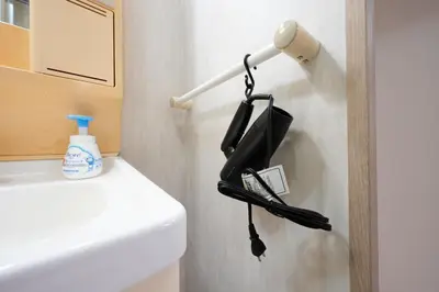 a bathroom with a black phone hanging on a wall at Shamrock Aoto 301 Cozy Tokyo Stay Near Station Airport Disney Access in Tokyo