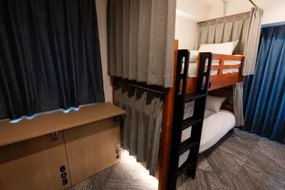 a bedroom with two bunk beds and a window at Wa Hostel in Tokyo