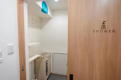 a wooden door in a room with a box at Wa Hostel in Tokyo