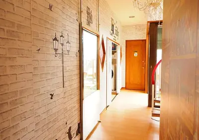 a hallway of a building with a brick wall at 301 Koiwa Grand House in Tokyo
