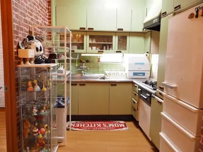 a kitchen with a refrigerator and a sink and a counter at 301 Koiwa Grand House in Tokyo