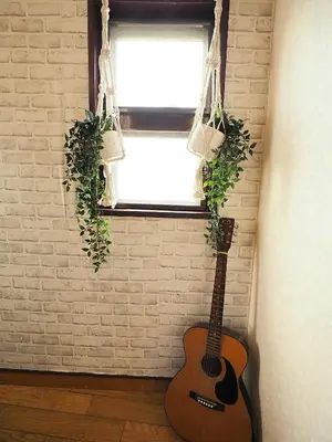 a guitar in a room next to a window at 301 Koiwa Grand House in Tokyo