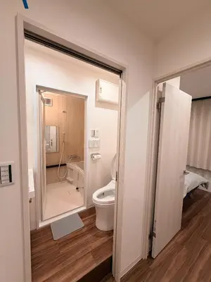 a bathroom with a toilet and a shower and a sink at C&H hotel3F in Tokyo