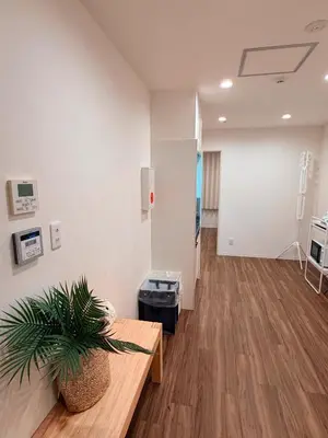 an empty room with a potted plant on a table at C&H hotel3F in Tokyo