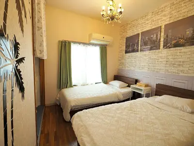 a bedroom with two beds and a window at Koiwa Guesthouse Tokyo in Tokyo