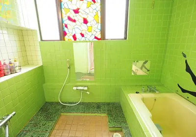 a green bathroom with a bath tub and a stained glass window at Koiwa Guesthouse Tokyo in Tokyo