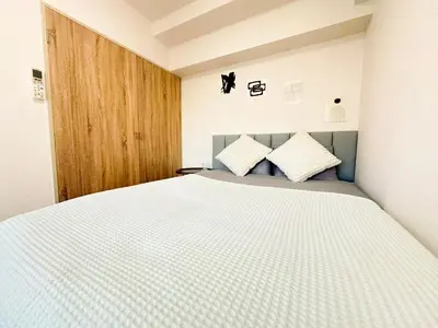 a bedroom with a white bed with two pillows at Shinjuku Kabukicho Cozy Bed&Living in Tokyo