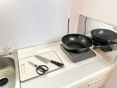 a miniature kitchen with a frying pan and scissors at Shinjuku Kabukicho Cozy Bed&Living in Tokyo