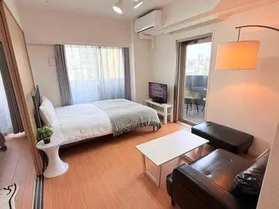 a small bedroom with a bed and a couch at Cozy APT Stay in Center Tokyo -SHIBUYA in Tokyo