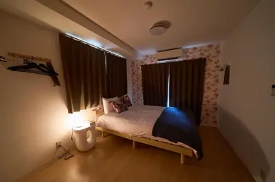 a small bedroom with a bed and a window at Clavis Asakusa Skytree in Tokyo