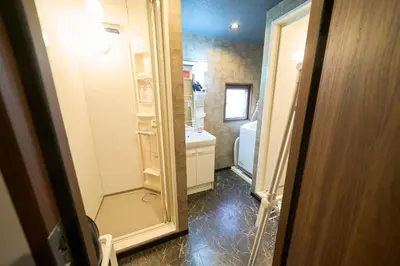 a bathroom with a shower and a sink and a toilet at Clavis Asakusa Skytree in Tokyo