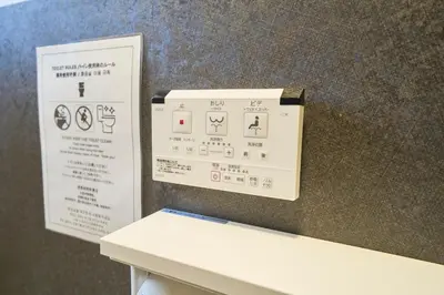 a sign on a wall next to a table at Clavis Asakusa Skytree in Tokyo