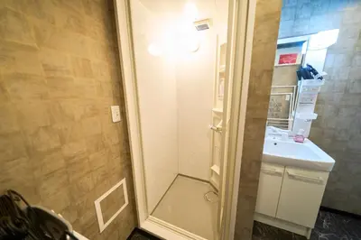 a small bathroom with a sink and a shower at Clavis Asakusa Skytree in Tokyo