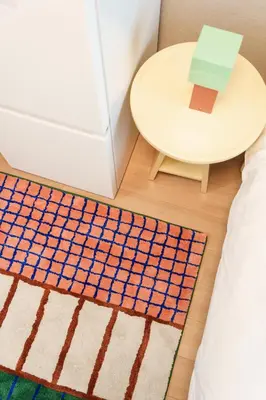 a bed room with a table and a rug at TORA HOTEL Kamata in Tokyo