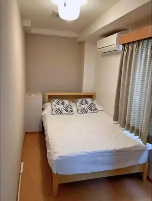 a bedroom with a bed with two pillows on it at Ginza401 Tsukiji 3mins,Tsukiji Market in Tokyo