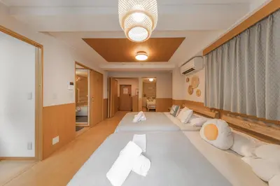 a room with a large bed with white pillows at Ginza401 Tsukiji 3mins,Tsukiji Market in Tokyo