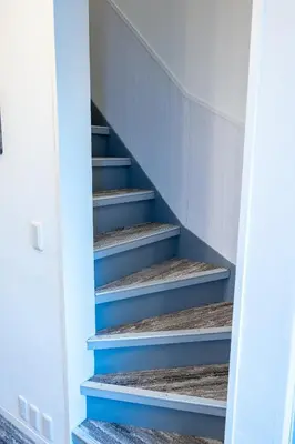 a stairwell with blue steps in a house at Hale Akasaka - The House in Tokyo