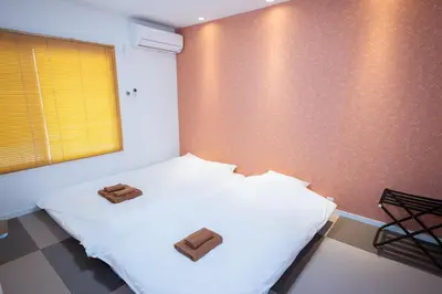 a bedroom with a bed with two towels on it at Hale Akasaka - The House in Tokyo