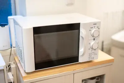 a microwave oven sitting on top of a table at Hale Akasaka - The House in Tokyo