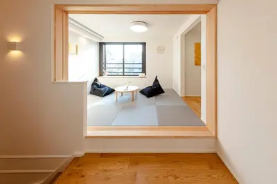 a room with a large window and a table at Hours House\u9ad8\u78021 in Tokyo