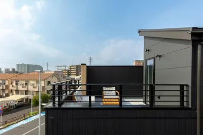 a balcony with a black railing on a building at Hours House\u9ad8\u78021 in Tokyo