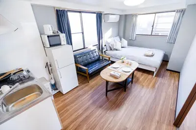 a small apartment with a kitchen and a living room at Charming Guesthouse in the Heart of Okubo \u4e36Steps to Metro and Convenient Travel! SoW in Tokyo