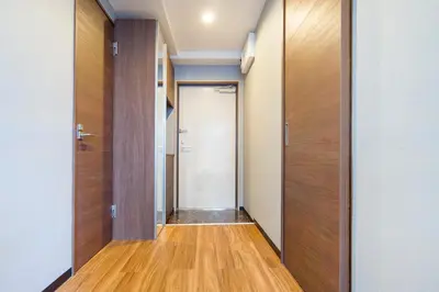 a hallway with wooden doors and wooden floors at Charming Guesthouse in the Heart of Okubo \u4e36Steps to Metro and Convenient Travel! SoW in Tokyo