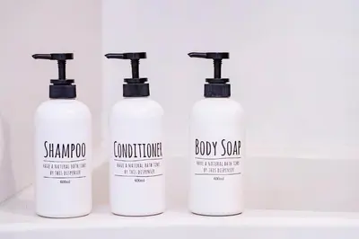four bottles of shampoo and conditioner on a shelf at Charming Guesthouse in the Heart of Okubo \u4e36Steps to Metro and Convenient Travel! SoW in Tokyo