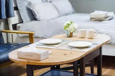 a coffee table with plates and cups and a bed at Charming Guesthouse in the Heart of Okubo \u4e36Steps to Metro and Convenient Travel! SoW in Tokyo