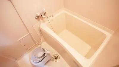 a bathroom with a tub with a toilet in it at \u30a8\u30de\u30fc\u30ec in Tokyo