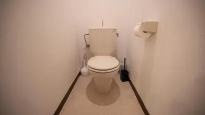 a bathroom with a white toilet in a stall at \u30a8\u30de\u30fc\u30ec in Tokyo