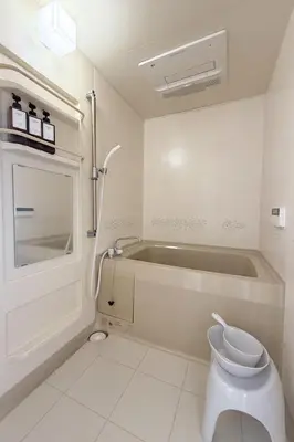 a bathroom with a tub and a toilet in it at MUGI Stay 301 in Tokyo