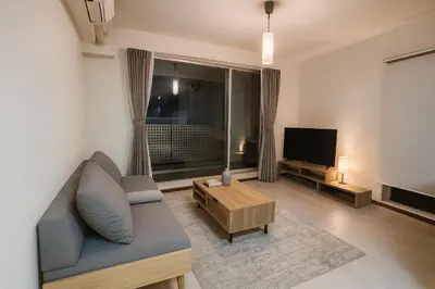 a living room with a couch and a television at MUGI Stay 301 in Tokyo