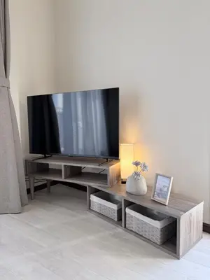 a living room with a flat screen tv on a entertainment center at MUGI Stay 301 in Tokyo