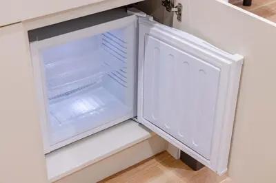 an empty refrigerator with its door open in a kitchen at \u4e80\u67095\u4e01\u76ee302 in Tokyo